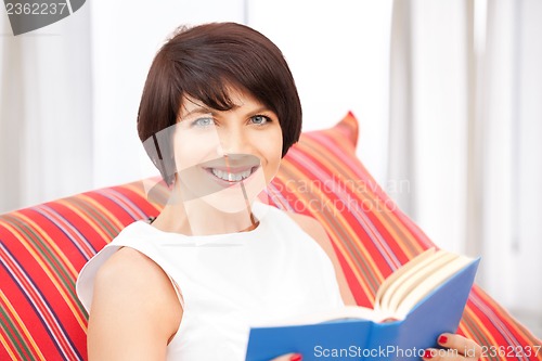 Image of happy and smiling woman with book