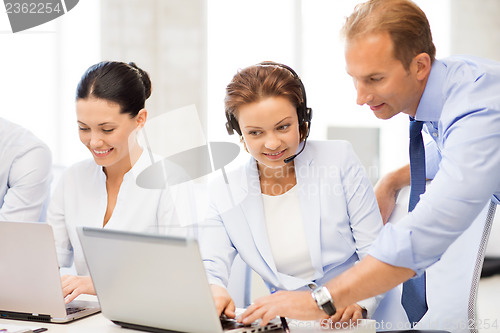 Image of group of people working in call center
