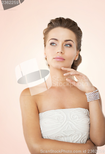 Image of woman with pearl earrings and bracelet