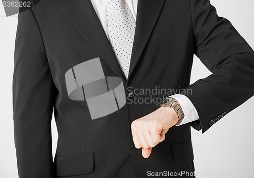 Image of man looking at wristwatch