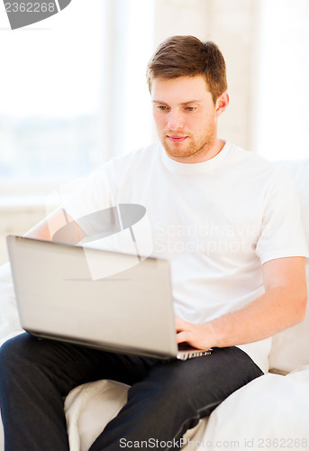 Image of man working with laptop at home