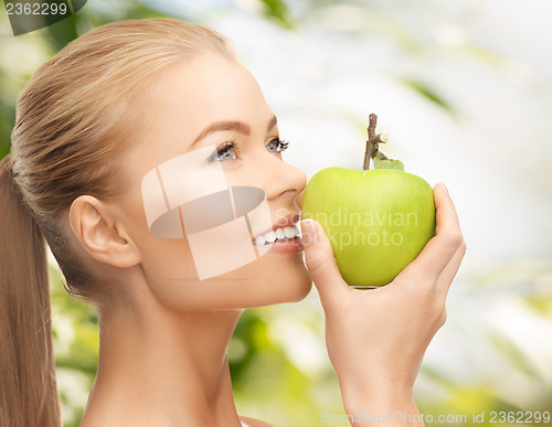 Image of woman smelling apple