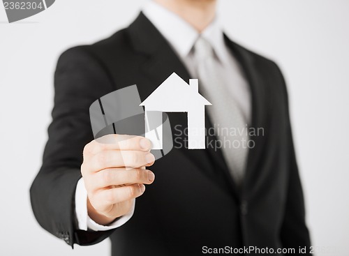 Image of man hand holding paper house