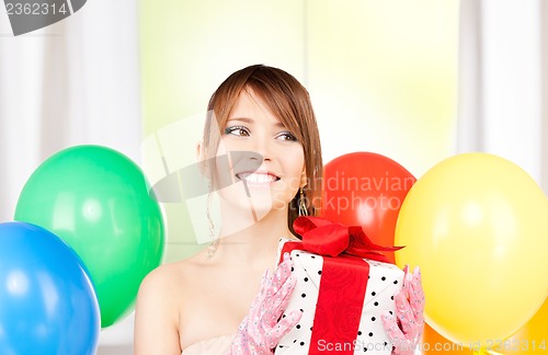 Image of party girl with balloons and gift box