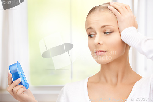 Image of woman holding alarm clock