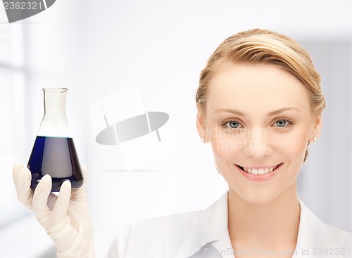 Image of female chemist holding bulb with chemicals