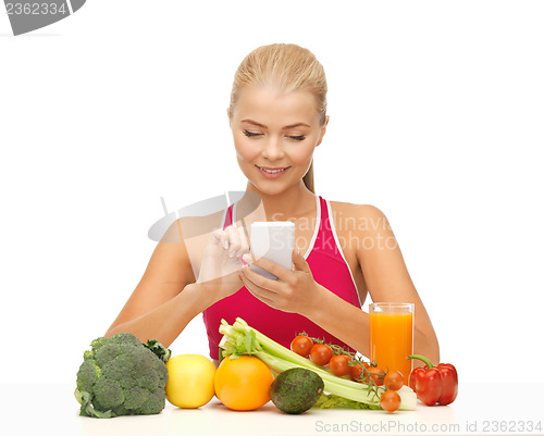 Image of woman with fruits, vegetables and smartphone