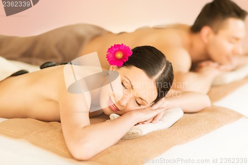 Image of couple in spa with hot stones