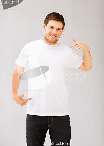 Image of man pointing at blank white t-shir
