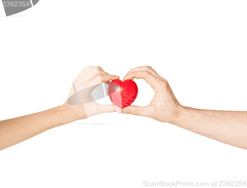 Image of woman and man hands with heart