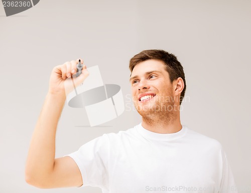 Image of man writing something in the air