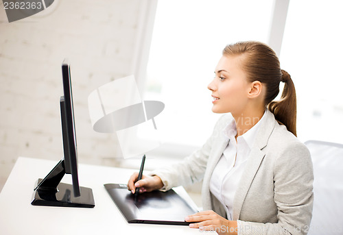 Image of businesswoman with drawing tablet in office