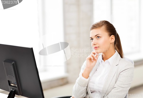 Image of pensive woman in office