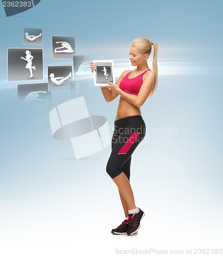 Image of woman holding tablet pc with sport application