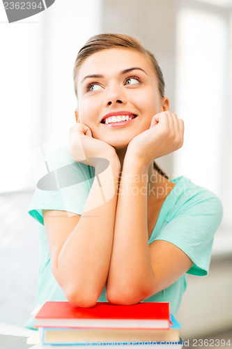 Image of happy smiling student girl with books
