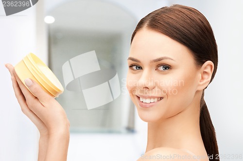 Image of beautiful woman with moisturizing creme