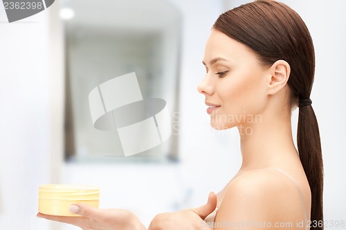 Image of beautiful woman with moisturizing creme