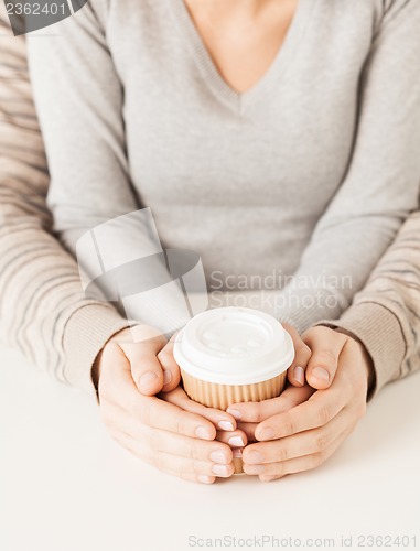 Image of woman and man with take away coffee cup
