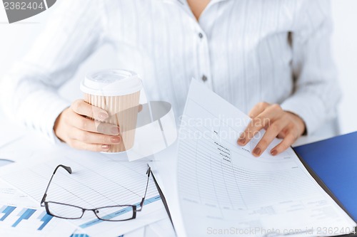 Image of woman hands with blank paper and coffee