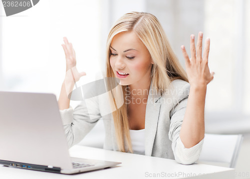 Image of angry woman with laptop