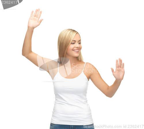 Image of woman in white t-shirt pressing imaginary button