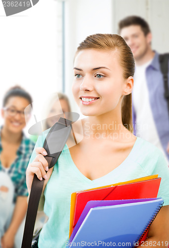 Image of student girl with school bag and color folders