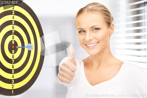 Image of businesswoman with dart and target