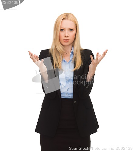 Image of young confused businesswoman with hands up