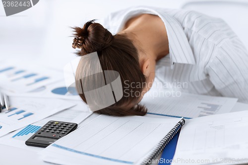 Image of woman sleeping at work in funny pose