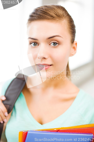 Image of student girl with school bag and color folders