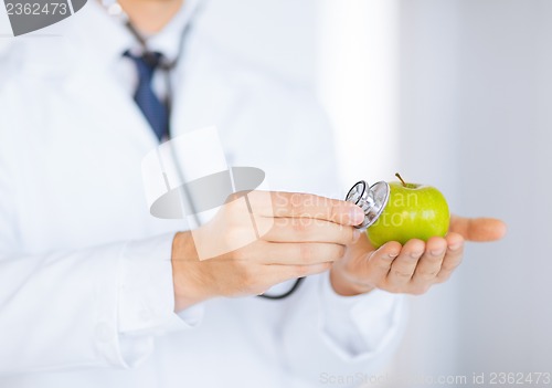Image of male doctor with green apple and stethoscope