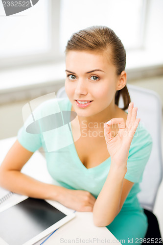 Image of girl with tablet pc showing ok gesture