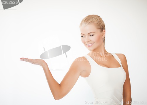 Image of woman in sportswear with empty hand