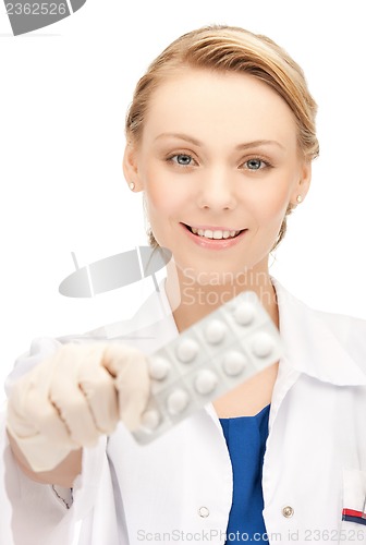 Image of female doctor with one pack of pills