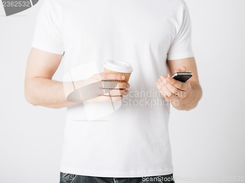 Image of man with smartphone and coffee