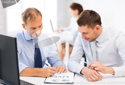 Image of businessmen with notebook on meeting