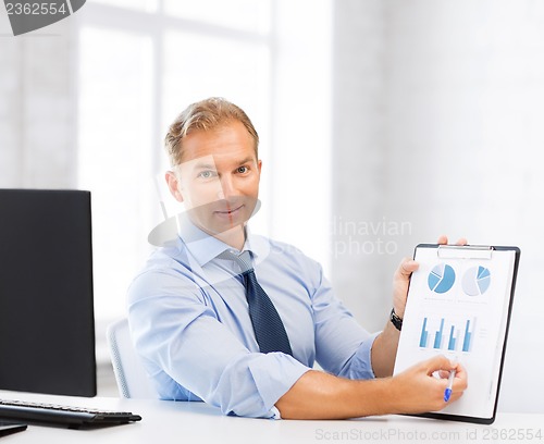 Image of businessman showing graphs and charts