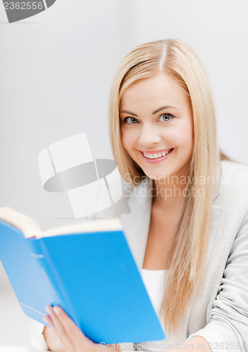 Image of young woman reading book