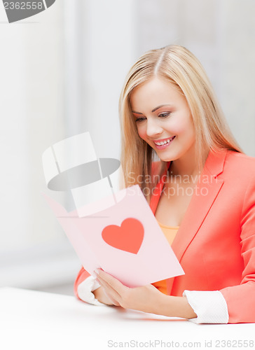 Image of woman holding postcard with heart shape