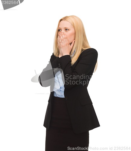 Image of businesswoman closing her mouth with hands