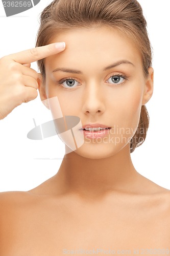 Image of beautiful woman touching her forehead