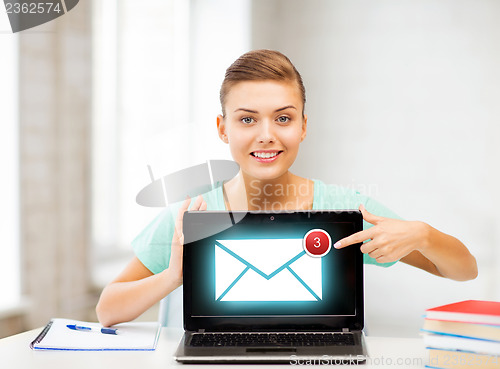 Image of smiling student girl with laptop at school