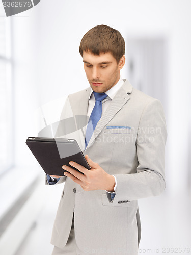 Image of calm man with tablet pc computer