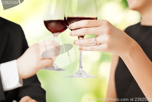 Image of engaged couple with wine glasses