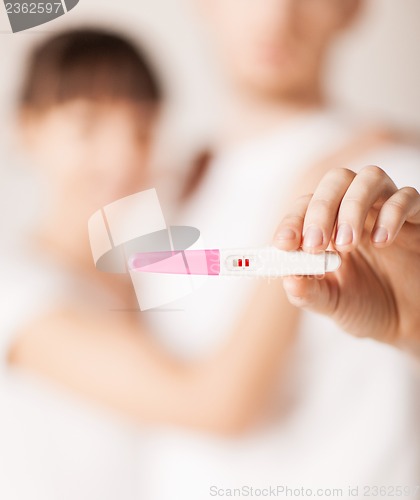 Image of woman and man hands with pregnancy test