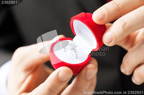 Image of man with wedding ring and gift box