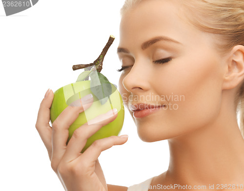 Image of woman smelling apple