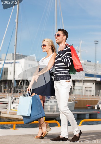 Image of young couple in duty free shopping bags