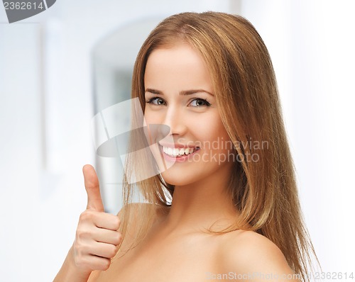 Image of beautiful woman showing thumbs up