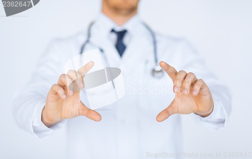 Image of doctor with holding something with hands